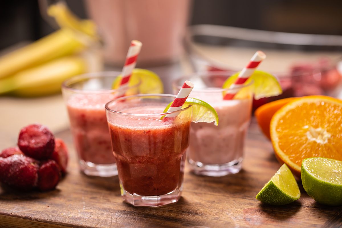 Strawberry smoothies with fresh fruit on a wooden board, simple products that are easy for first creators to film